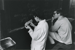 Kitty Rauscher ’67 and John Tucker ’69 confer in a chemistry lab, fall 1966. by Joseph Consentino