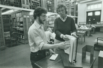 Librarian Jane Hryshko assists a student in the use of a periodicals finding aid in the Hoffman Reading Room, ca. 1983.