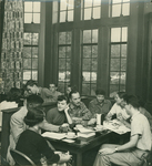 A group of students sit with Gerard DeGre (center) and Joan Larkey (in profile on right) in the Hegeman Coffee Shop, ca. 1955. by Hans Knopf