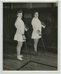 Two female fencers pose in the Memorial Gymnasium, late 1940s.